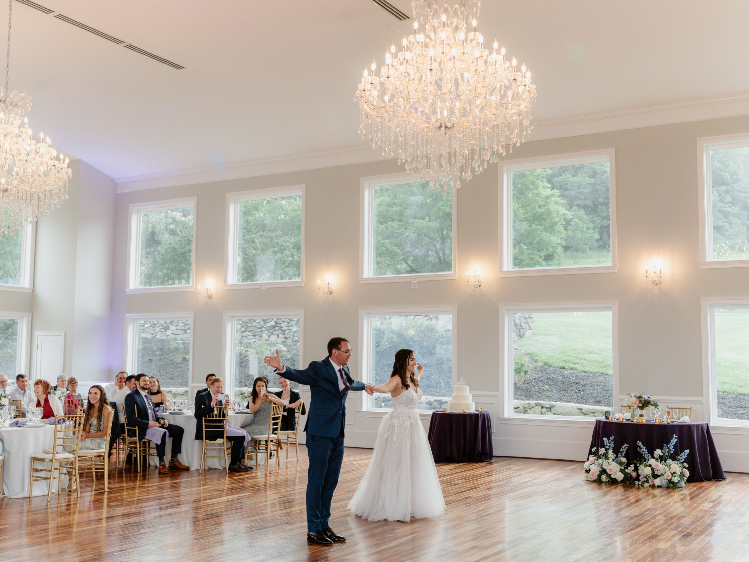Couple entering the ballroom for their reception at a scenic Bluemont VA wedding under crystal chandeliers
