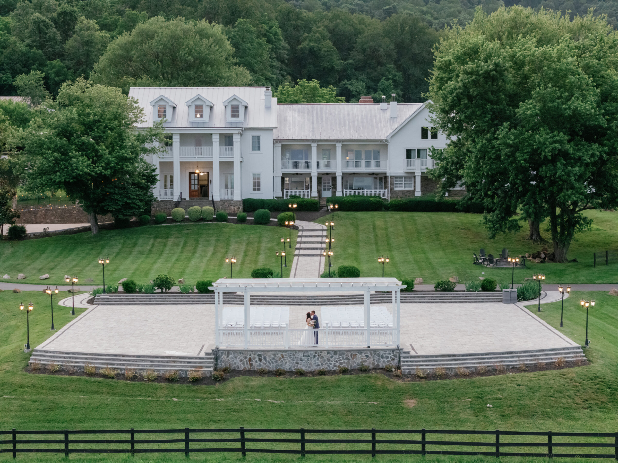 Drone portrait of the couple at the ceremony site with The View at Bluemont venue and rolling hills in the background during a scenic Bluemont VA wedding